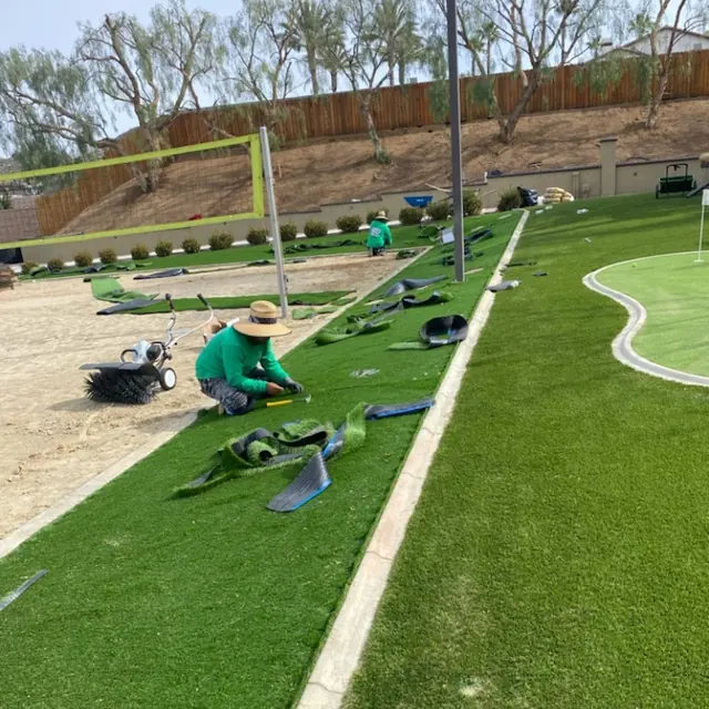 Millenium crew seaming turf next to a putting green in Perris, CA