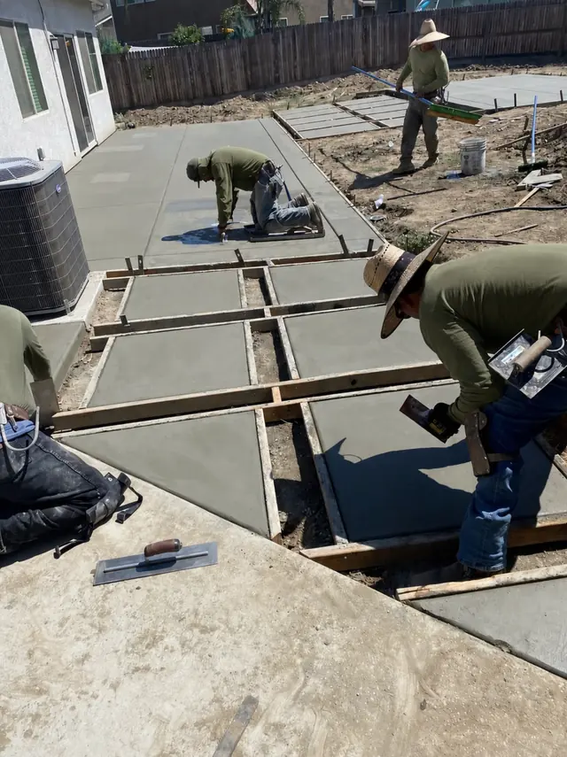 Crew pouring concrete in forms in Perris, CA