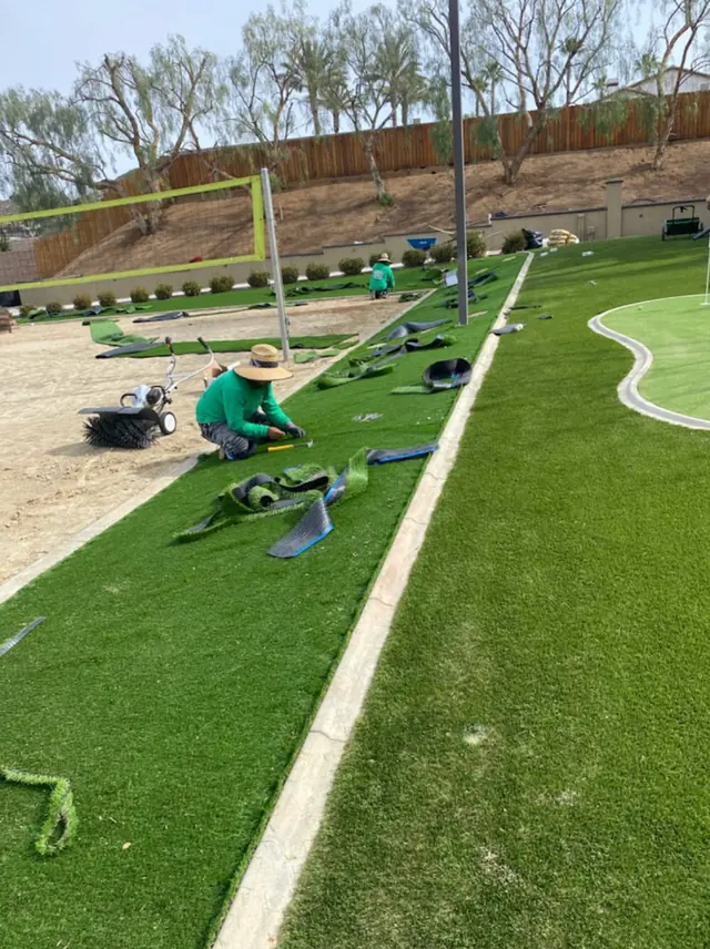 Crew finishing the turf edge on a job in Perris, CA
