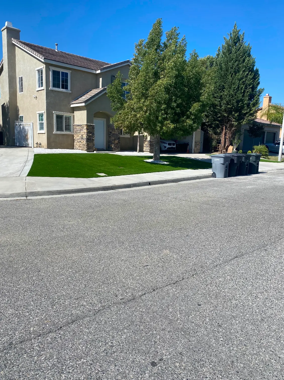 Concrete driveway and sidewalk with artificial grass in Perris, CA