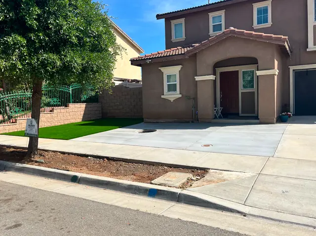Artificial turf front yard with concrete walkway in Perris, CA