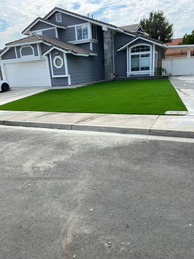 Residential artificial grass by a driveway in Perris, CA